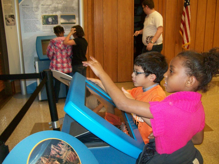 Children using touch screens in an exhibit