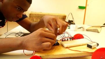 young person working on electrical circuit