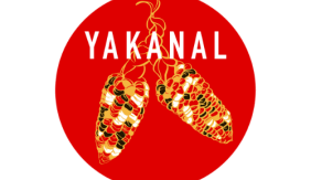 Image is a red circle with an illustration of two corn cobs in red, green, white, and yellow. The word "YAKANAL" is displayed in white in all uppercase at the top.