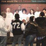 Museum visitors examine a photo of how the U.S. Census counted different races over time.
